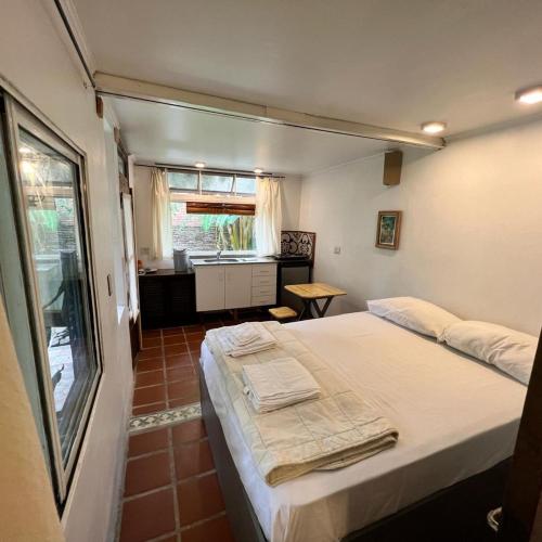 a bedroom with a bed in a room with a window at Nido, Los Colibríes VI in Tigre