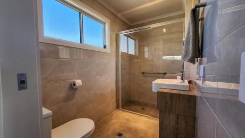 a bathroom with a toilet and a sink at Moonta Bay Holiday Park in Port Moonta