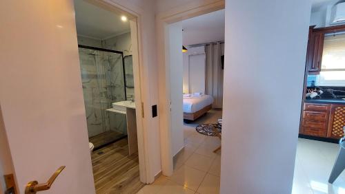 a bathroom with a shower and a bedroom at NisoVillas in Volos