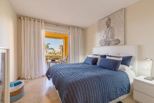 a bedroom with a bed with a blue comforter at Cumbres del Rodeo in Marbella