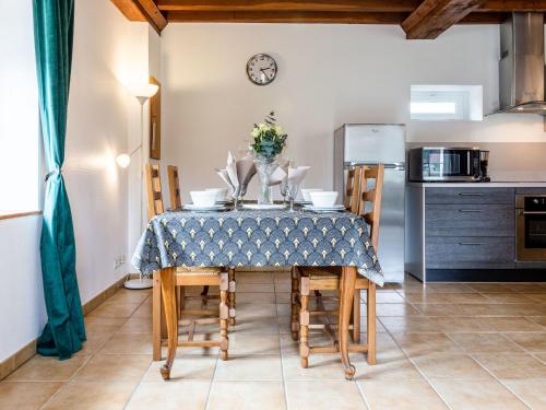 a kitchen and dining room with a table and chairs at Holiday Home Le Clos Renard - COM401 by Interhome in Commes