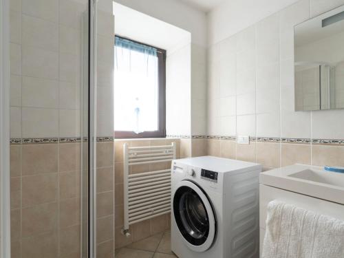 a bathroom with a washing machine and a sink at Apartment A' Ca' de Alida by Interhome in Ortovero