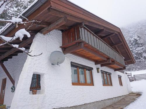 a building with a balcony on the side of it at Holiday Home Waldruh by Interhome in Telfs