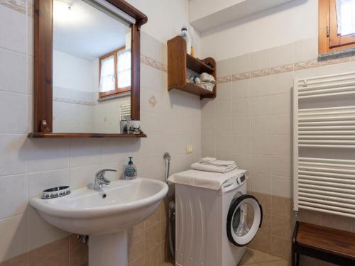 a bathroom with a sink and a washing machine at Apartment Daniele by Interhome in Onzo