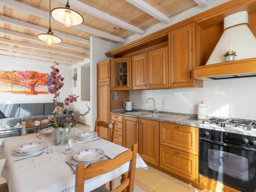 een keuken met houten kasten en een tafel met stoelen bij Apartment Casa 51 by Interhome in Erli