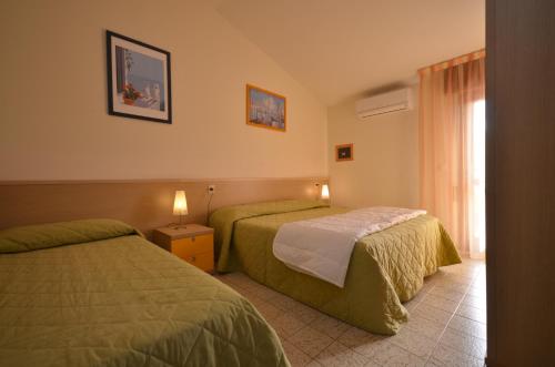 A bed or beds in a room at Villaggio Selene