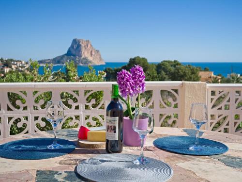 a table with two glasses and a bottle of wine at Villa Castillo by Interhome in La Canuta