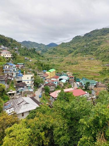 a small town in a valley with mountains at Banaue Transient House Bed and Breakfast in Banaue