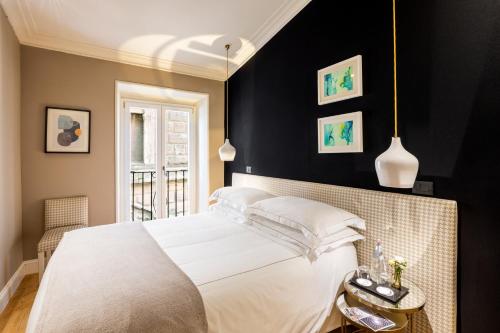a bedroom with a white bed and black walls at Nerva Boutique Hotel in Rome