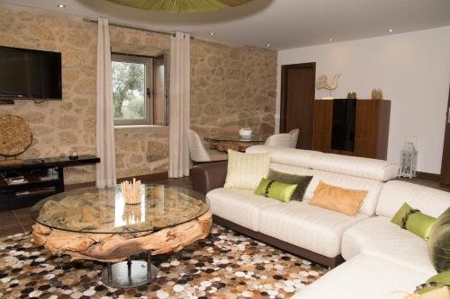 a living room with two couches and a coffee table at Casas do Regato in Castelo Branco