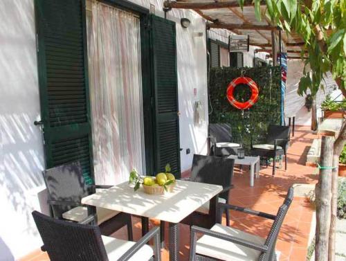 a table with a bowl of fruit on a patio at Eden Holiday in Minori