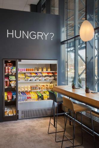 a grocery store with a refrigerator filled with food at Park Inn by Radisson Oslo Airport Hotel West in Gardermoen