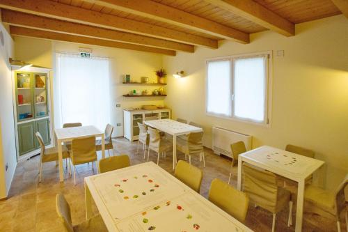 a dining room with tables and chairs and a window at Agrestia azienda agricola in Bertinoro