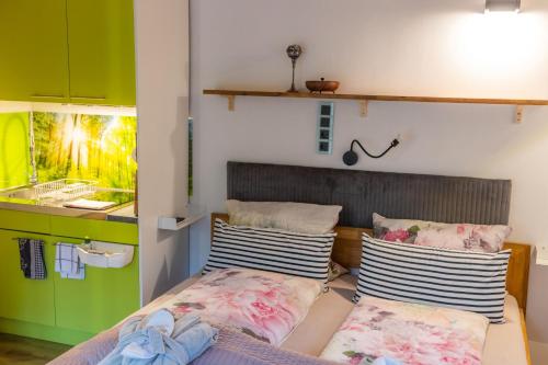 a bedroom with a bed and two pillows on it at Holzwerk Oybin in Kurort Oybin