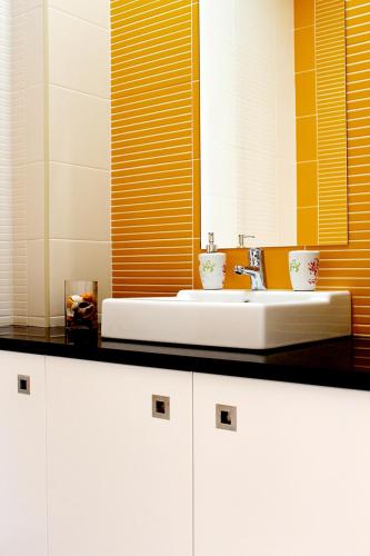 a bathroom with a white sink and a mirror at Solmar Alojamentos in Ponta Delgada