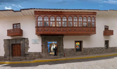 a building with a balcony on the side of it at Aranwa Cusco Boutique Hotel in Cusco