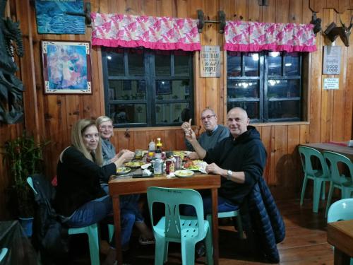 a group of people sitting at a table in a restaurant at Las vegas lodge and restaurant in Banaue