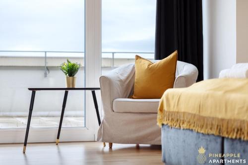 a living room with a chair and a table at Pineapple Apartments Penthouse am Zwinger - 162 qm - 1x free parking in Dresden
