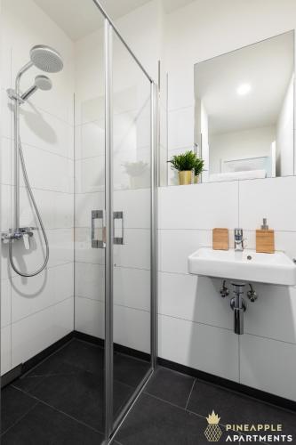 a bathroom with a shower and a sink at Pineapple Apartments Penthouse am Zwinger - 162 qm - 1x free parking in Dresden