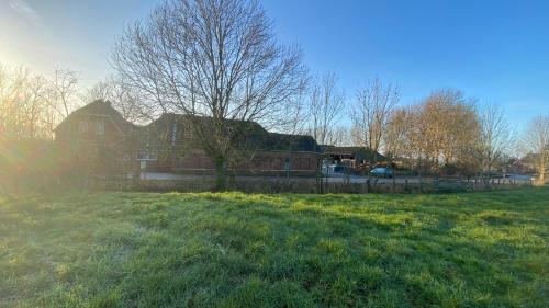 a large house with a fence in a field at The Horse Farm in Garnwerd