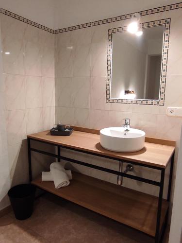 a bathroom with a sink and a mirror at Hostal Nadal in Sóller