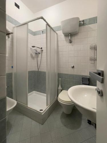 a bathroom with a shower and a toilet and a sink at La Lanterna in Silvi Marina