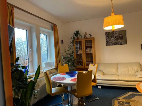 a living room with a table and a couch at Der Falkenhorst in Bad Sachsa