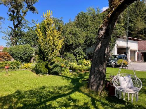 a swing hanging from a tree in a yard at Apartment Moser-2 by Interhome in Stein an der Enns