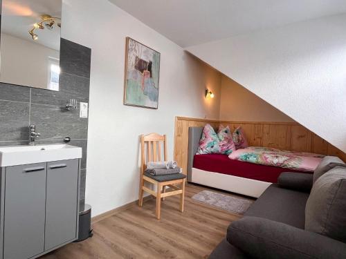 a small room with a bed and a sink and a couch at Apartment Moser by Interhome in Stein an der Enns