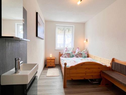 a small bedroom with a bed and a sink at Apartment Moser by Interhome in Stein an der Enns