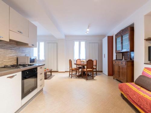 a kitchen and living room with a table and chairs at Apartment Casa dalla Mamma by Interhome in Montalto Ligure