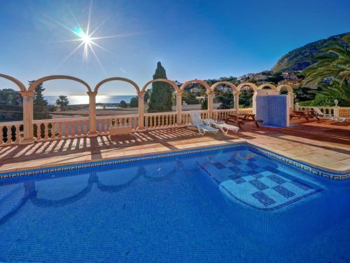 a large swimming pool in a yard with a fence at Apartment Canuta Baja-6 by Interhome in La Canuta