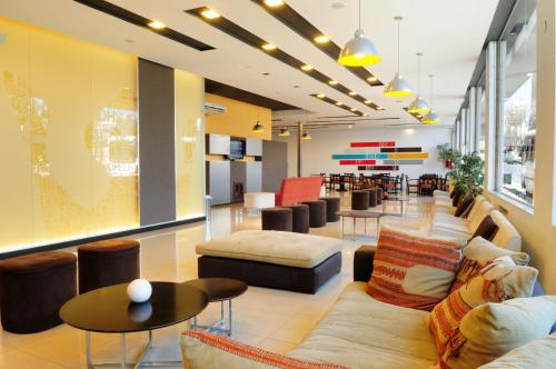 a lobby of a store with couches and tables at Hotel Presidente in Villa Carlos Paz