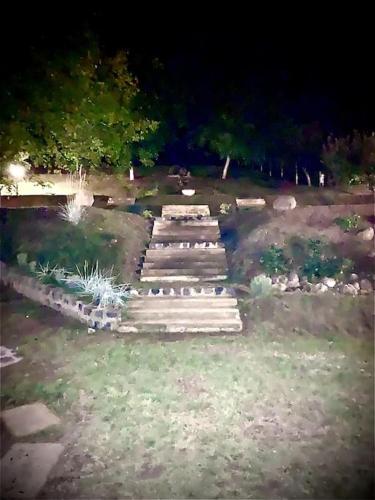 a group of steps in a yard at night at Manor House on the Danube Bend in Tahitótfalu
