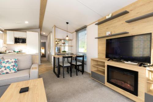 a living room with a large flat screen tv and a living room at Mowbreck Park in Kirkham