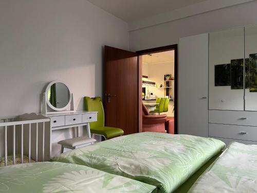 a bedroom with a bed and a desk and a mirror at Der Falkenhorst in Bad Sachsa
