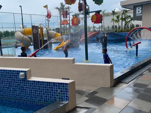 a water park with children playing in the water at Js homestay in Melaka