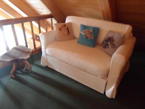 a living room with a couch with pillows at Chalet Atelier in Davos
