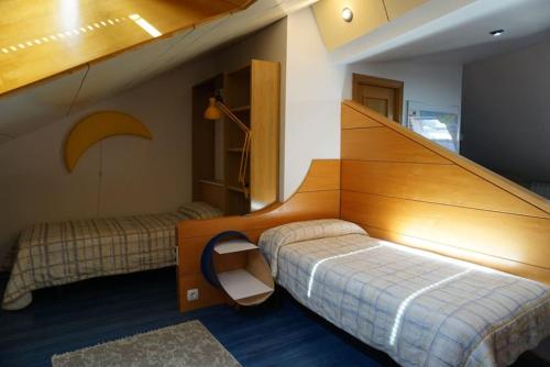 1 dormitorio con 1 cama con cabecero de madera en BaruHaus urbanizacion con piscina Villamañan, 