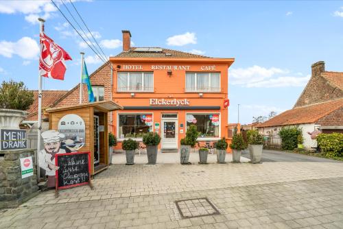 a building with a sign in front of it at Elckerlyck Inn Hotel in Rollegem