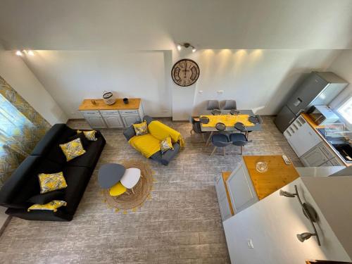 an overhead view of a living room with a couch and a table at La Remise de Guytou et Spa in Cheval-Blanc