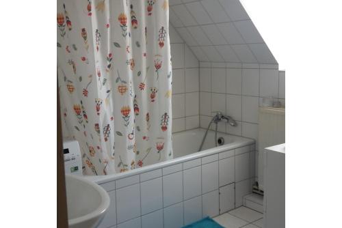a bathroom with a tub and a shower curtain at Private Room in Hannover