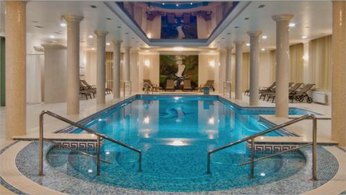 a large swimming pool in a hotel lobby at Solva Resort & SPA in Polyana