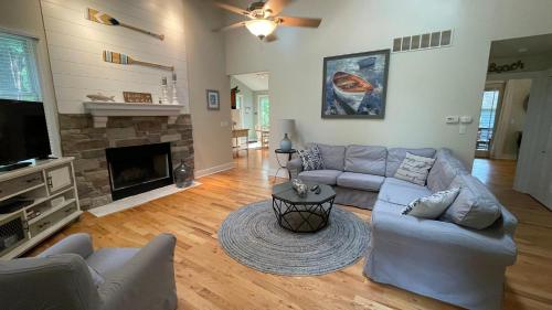 a living room with a couch and a fireplace at Just Beachy in Union Pier