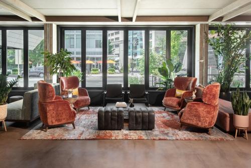 a lobby with chairs and a table with luggage at Vignette Collection Yours Truly DC by IHG in Washington