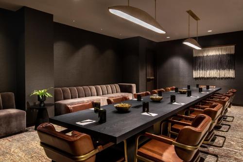 a conference room with a long table and leather chairs at Vignette Collection Yours Truly DC by IHG in Washington