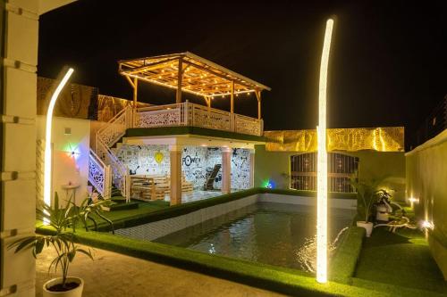 a house with a swimming pool at night at Adorable 1-Bedroom-Apt With 24hrs Electricity & Unlimited Internet in Lagos