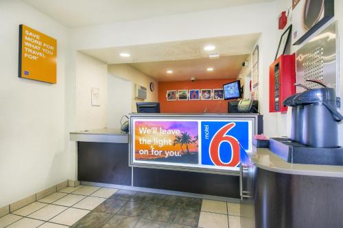 a waiting area of a fast food restaurant with a sign at Motel 6-Chino, CA - Los Angeles Area in Chino