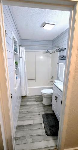 a white bathroom with a toilet and a sink at F Lakefront! Remodeled, Sleeps 4, Boat Slip, Patio, WiFi, Cable, Pool in Osage Beach