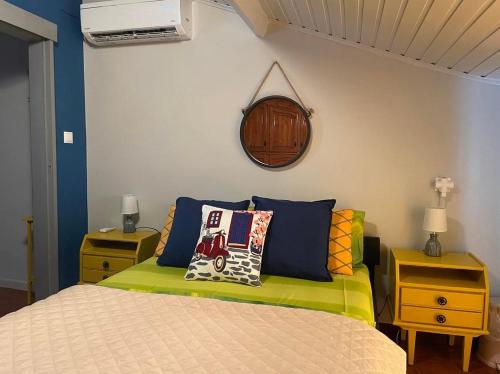 a bedroom with a bed with colorful pillows on it at Aegean Blu Port House Pythagoreio in Pythagoreio